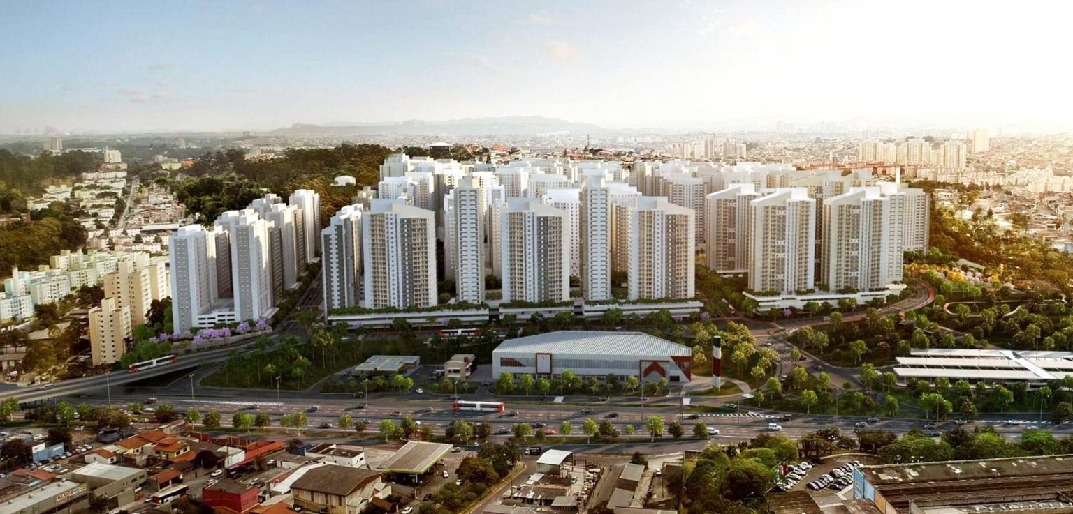 Vista aérea do conjunto habitacional de São Paulo com dezenas de torres residenciais cercadas por áreas verdes e vias urbanas.