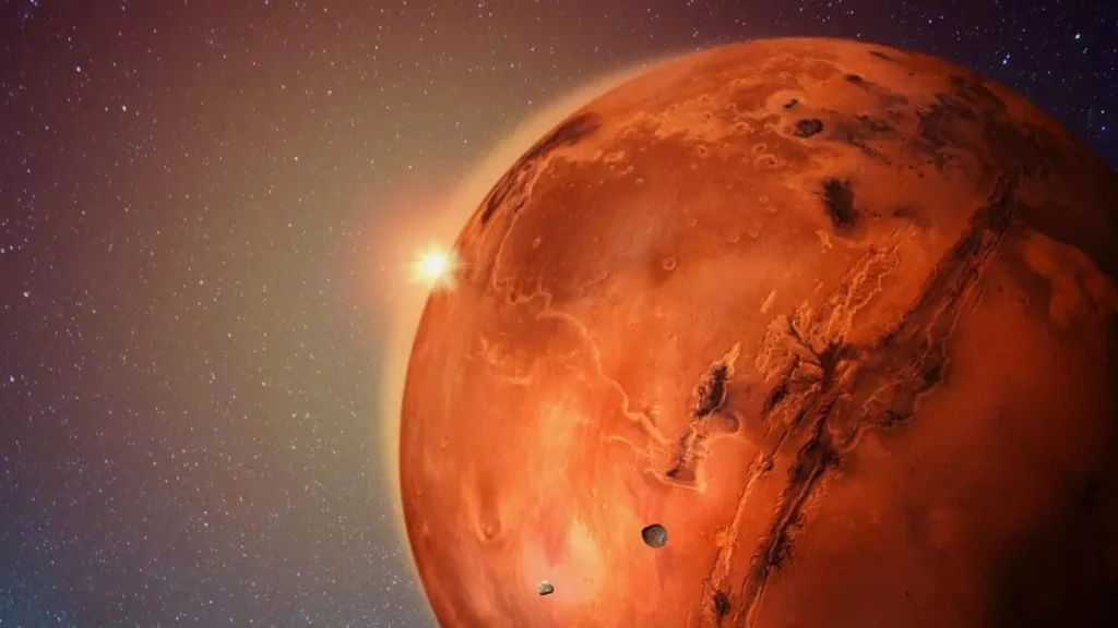 Planeta Marte visto de perto, com superfície avermelhada, crateras visíveis e o sol brilhando ao fundo no espaço.
