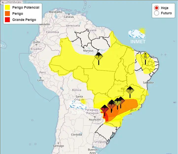 Mapa do Brasil exibindo áreas de alerta meteorológico coloridas. Uma mancha vermelha de "Grande Perigo" cobre a região Sul, cercada por faixas laranja e amarela que se estendem até o Sudeste e Centro-Oeste.